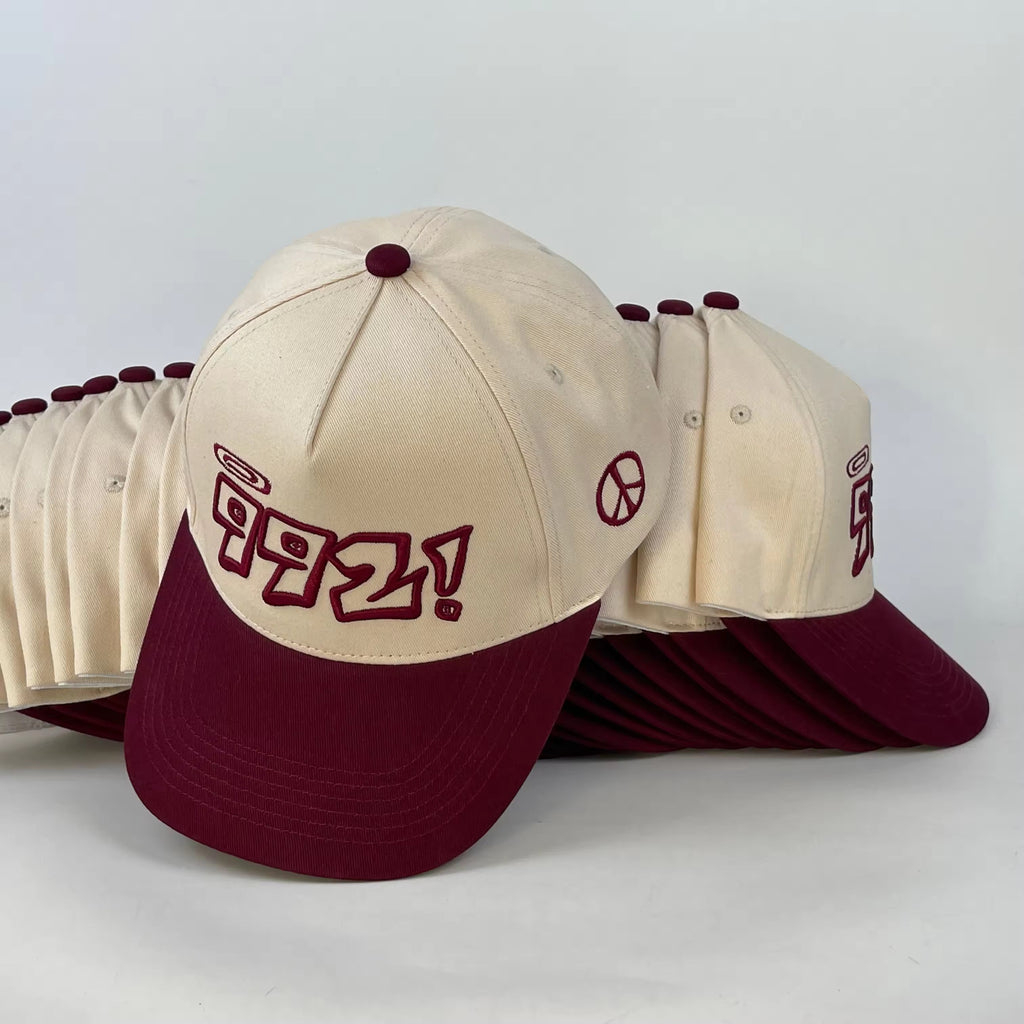 baseball cap in burgundy and cream
